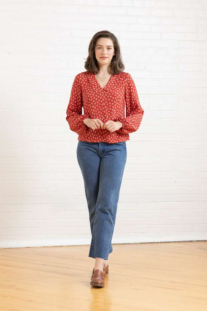 Woman wearing red floral Cosmo blouse