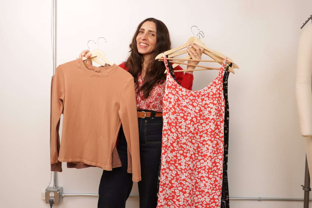 Sarai holding up sewing projects