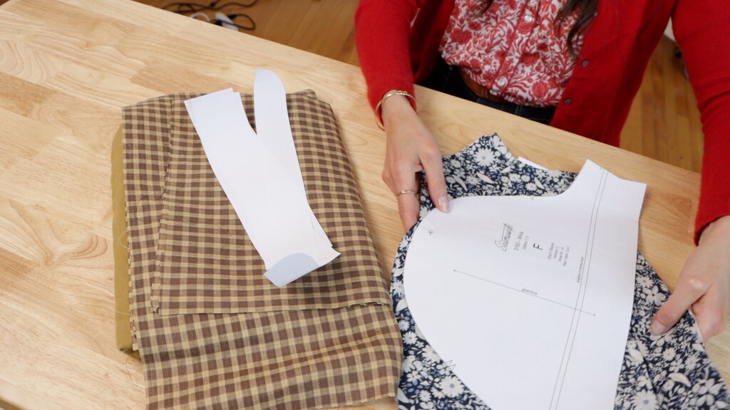 cutting table with multiple pattern pieces laid out for different projects
